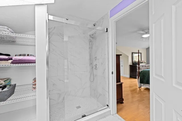 a bathroom with a glass shower door