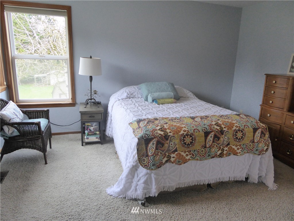 9527 Gastaeson Lane Southwest Rochester, WA 98579 - Photo 22 of 40 a bedroom with a bed and window