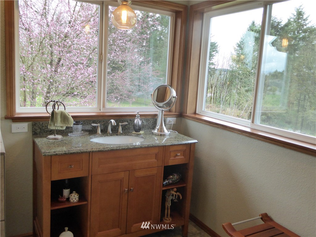 9527 Gastaeson Lane Southwest Rochester, WA 98579 - Photo 23 of 40 a dining table sitting next to a window