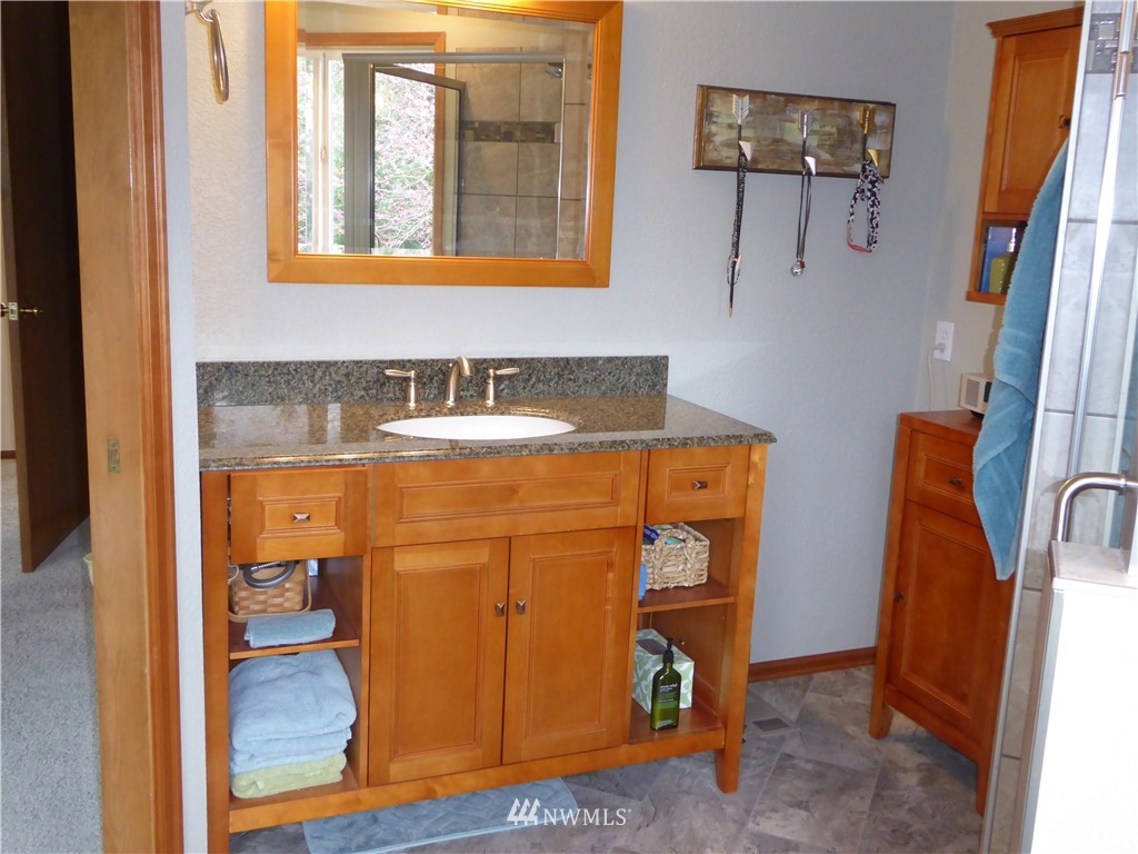 9527 Gastaeson Lane Southwest Rochester, WA 98579 - Photo 25 of 40 a bathroom with a sink and a mirror