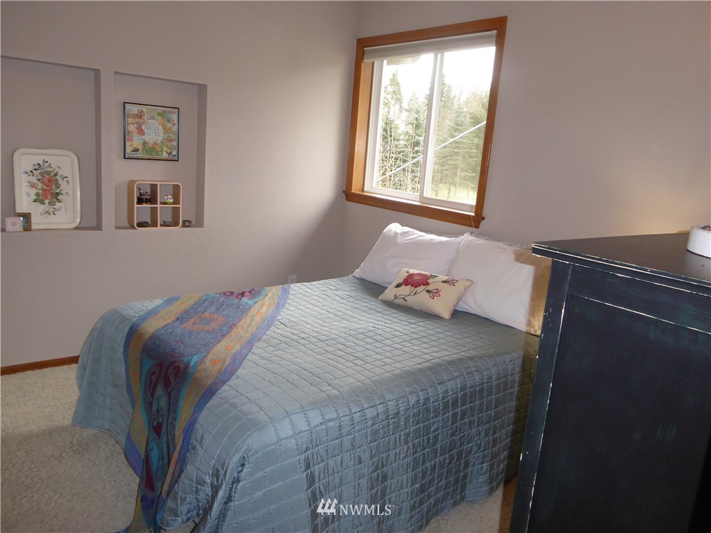 9527 Gastaeson Lane Southwest Rochester, WA 98579 - Photo 26 of 40 a bedroom with a bed and a window