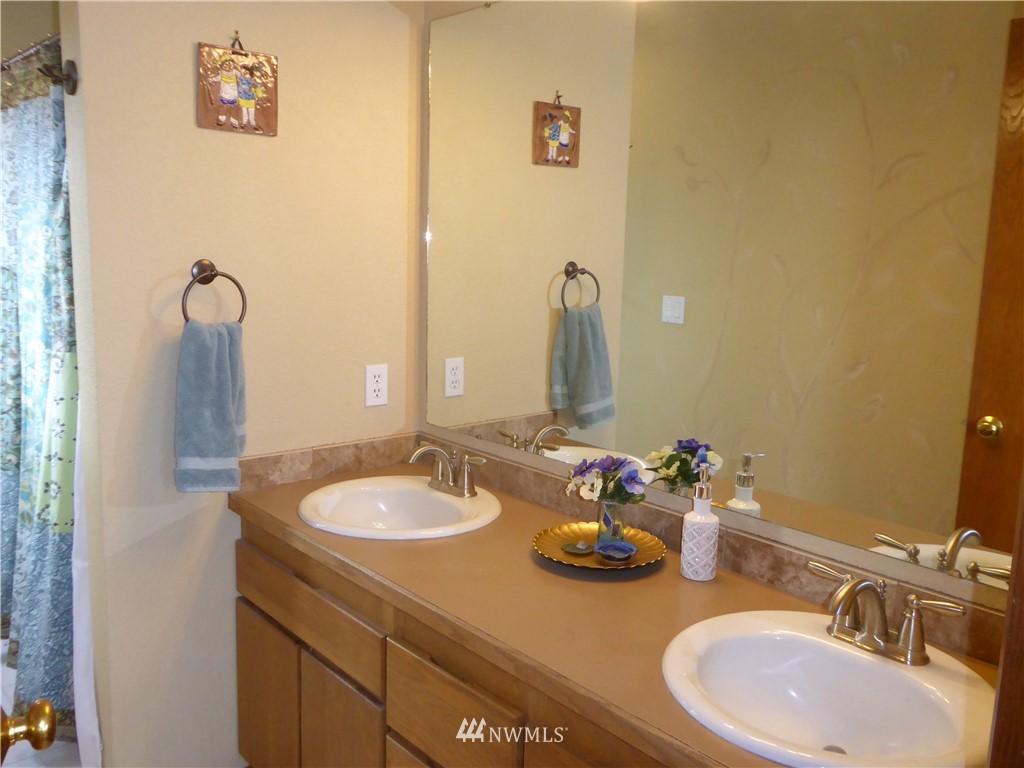 9527 Gastaeson Lane Southwest Rochester, WA 98579 - Photo 30 of 40 a bathroom with a sink and a mirror