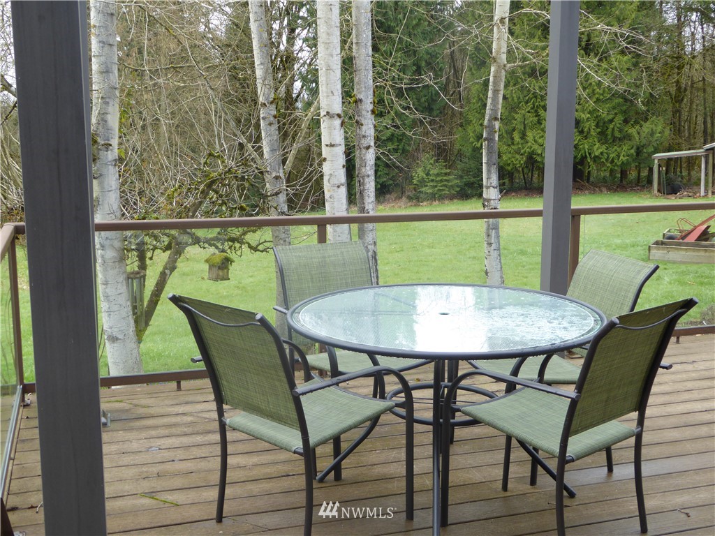 9527 Gastaeson Lane Southwest Rochester, WA 98579 - Photo 31 of 40 a view of a chairs and table on the deck