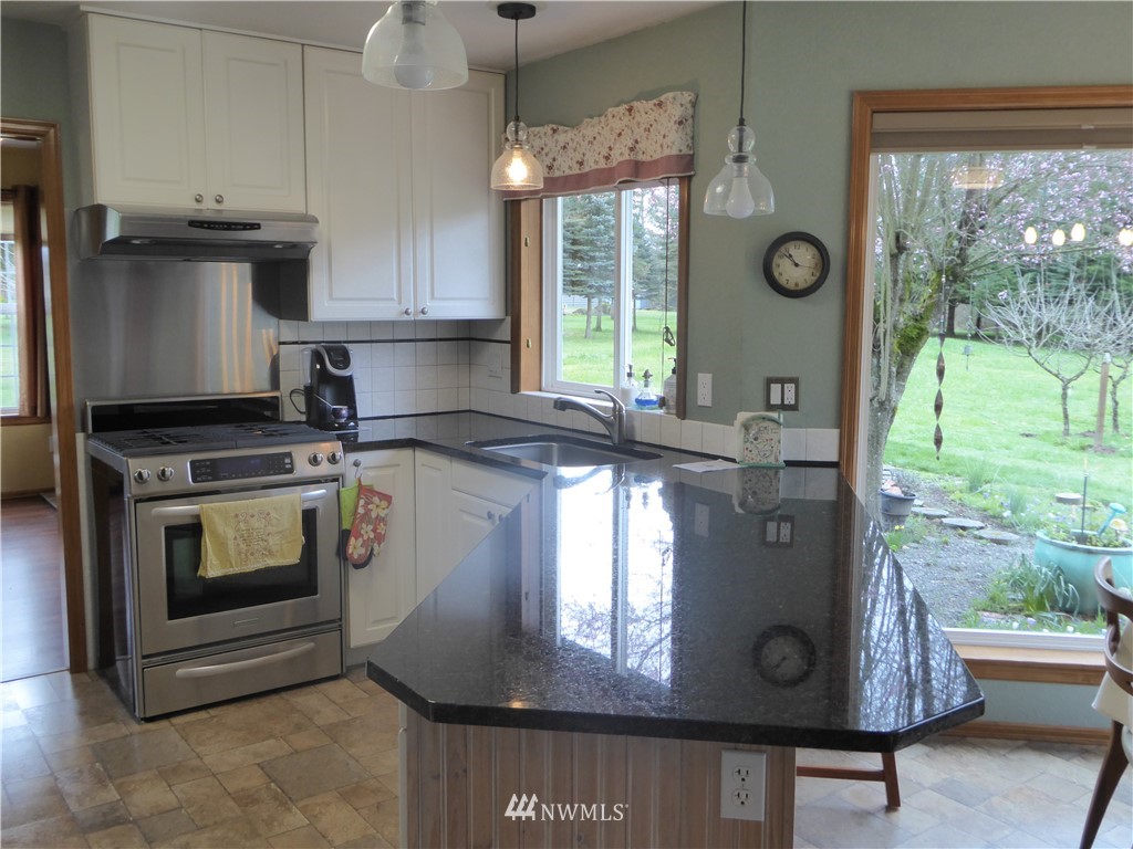 9527 Gastaeson Lane Southwest Rochester, WA 98579 - Photo 9 of 40 a kitchen with stove and window