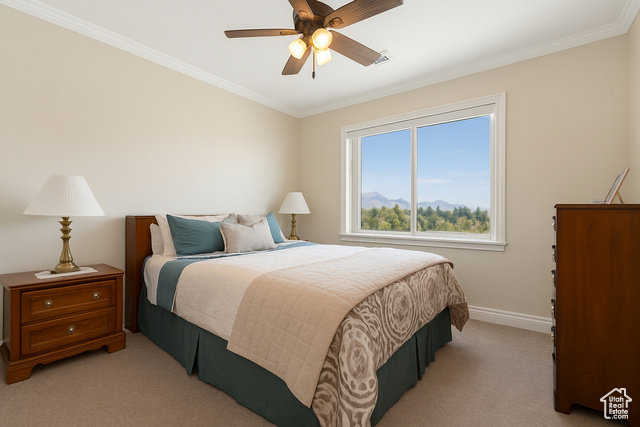 230 Boulder Way Leeds, UT 84746 - Photo 26 of 72 2nd bedroom featuring crown molding, light colored carpet, ceiling fan, mirrored wardrobe sliding doors and a mountain view