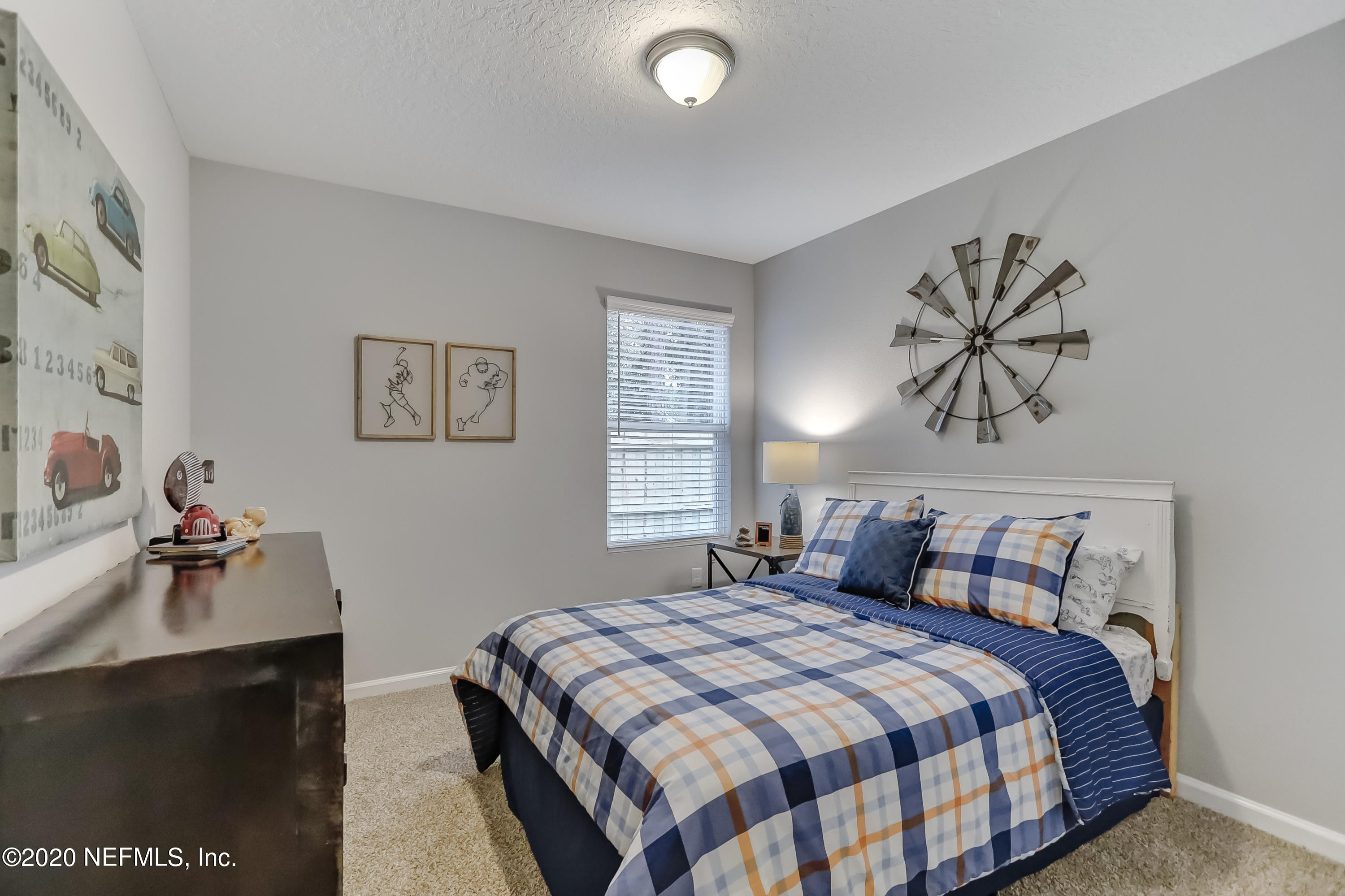5422 Kennerly Road Jacksonville, FL 32207 - Photo 15 of 41 a bedroom with a bed and a chandelier