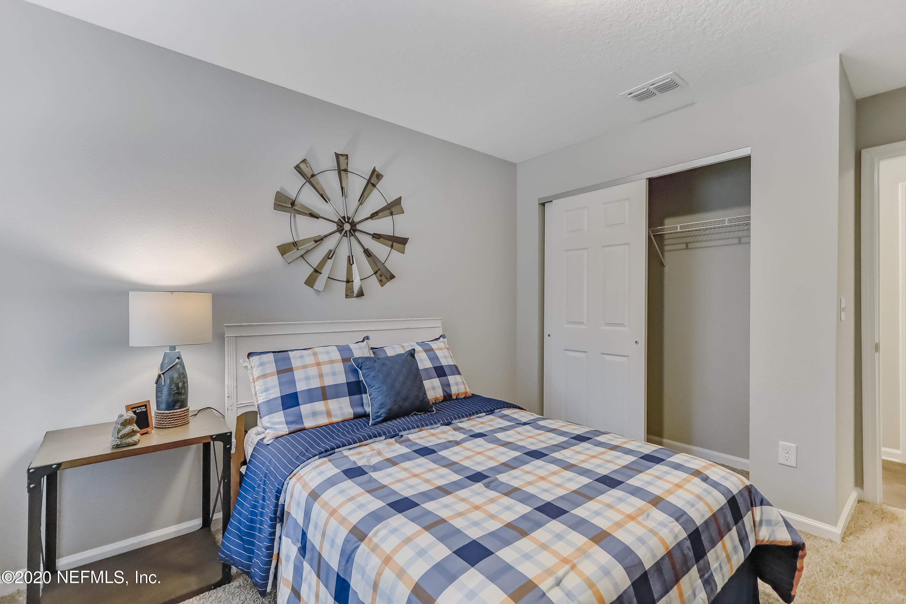 5422 Kennerly Road Jacksonville, FL 32207 - Photo 16 of 41 a bedroom with a bed and a chandelier