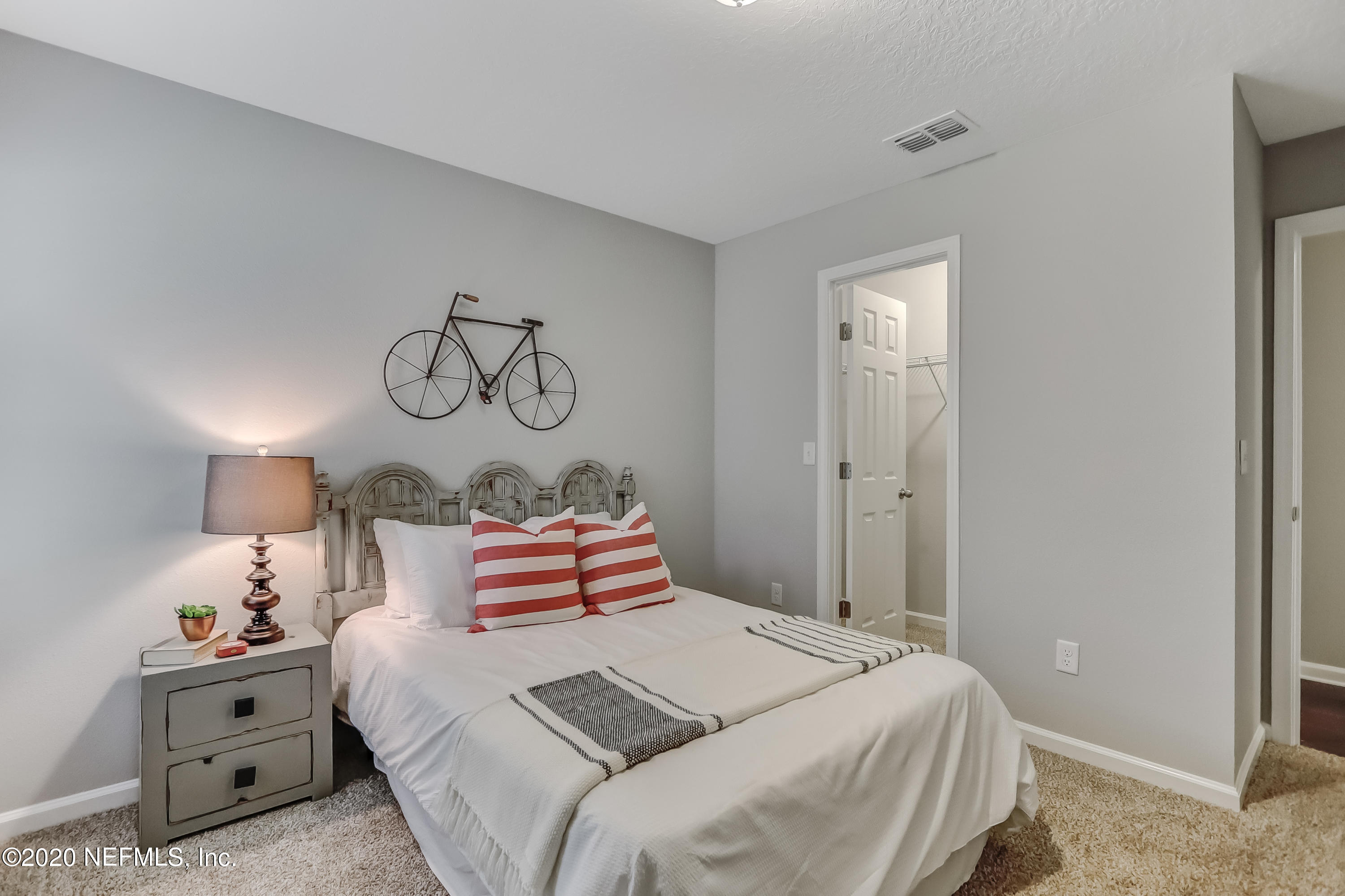 5422 Kennerly Road Jacksonville, FL 32207 - Photo 18 of 41 a bedroom with bed and cabinets