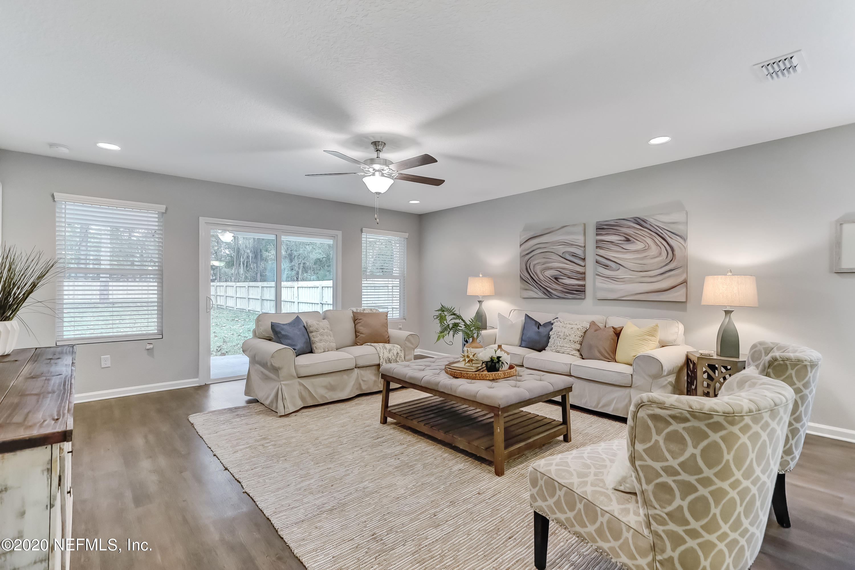 5422 Kennerly Road Jacksonville, FL 32207 - Photo 25 of 41 a living room with furniture a large window and a chandelier