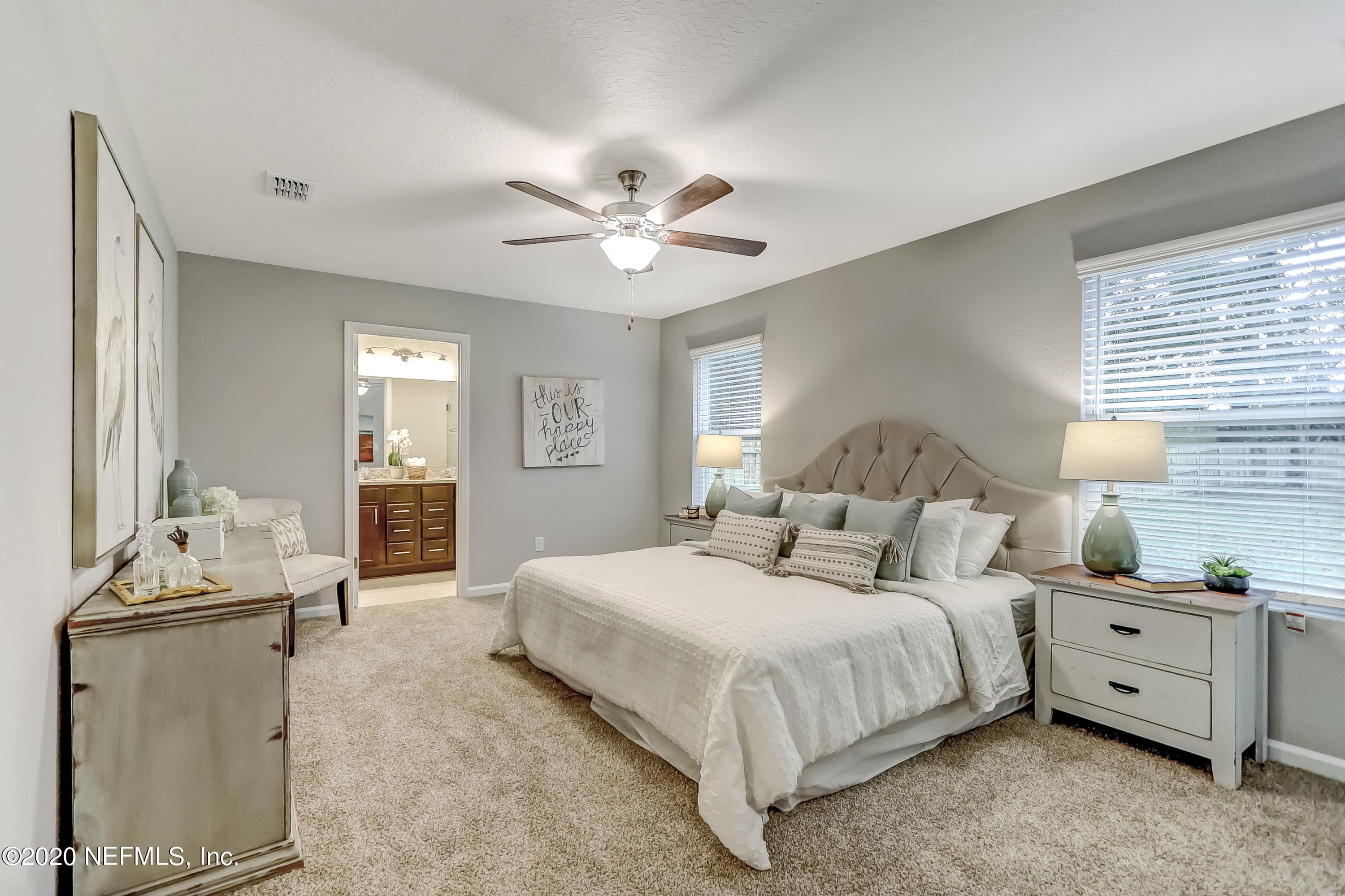 5422 Kennerly Road Jacksonville, FL 32207 - Photo 30 of 41 a bedroom with a bed and a chandelier