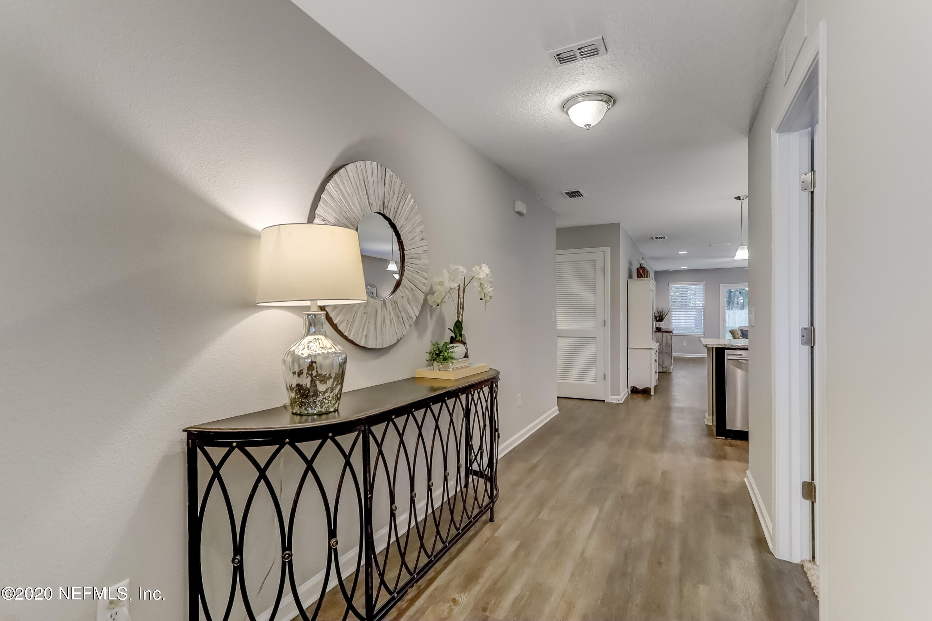 5422 Kennerly Road Jacksonville, FL 32207 - Photo 3 of 41 a view of a hallway to a livingroom and a chandelier