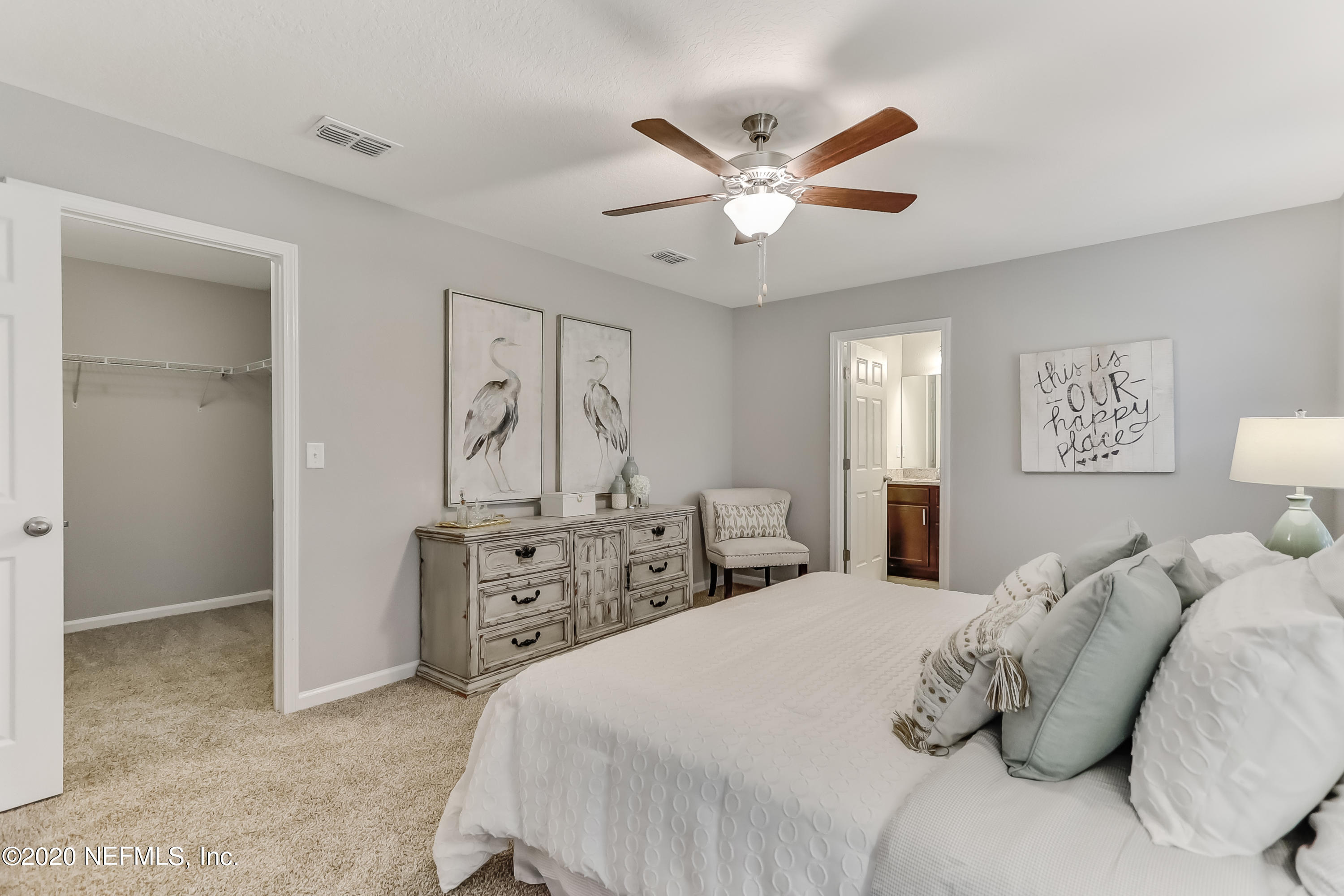 5422 Kennerly Road Jacksonville, FL 32207 - Photo 31 of 41 a bedroom with a large bed and a chandelier