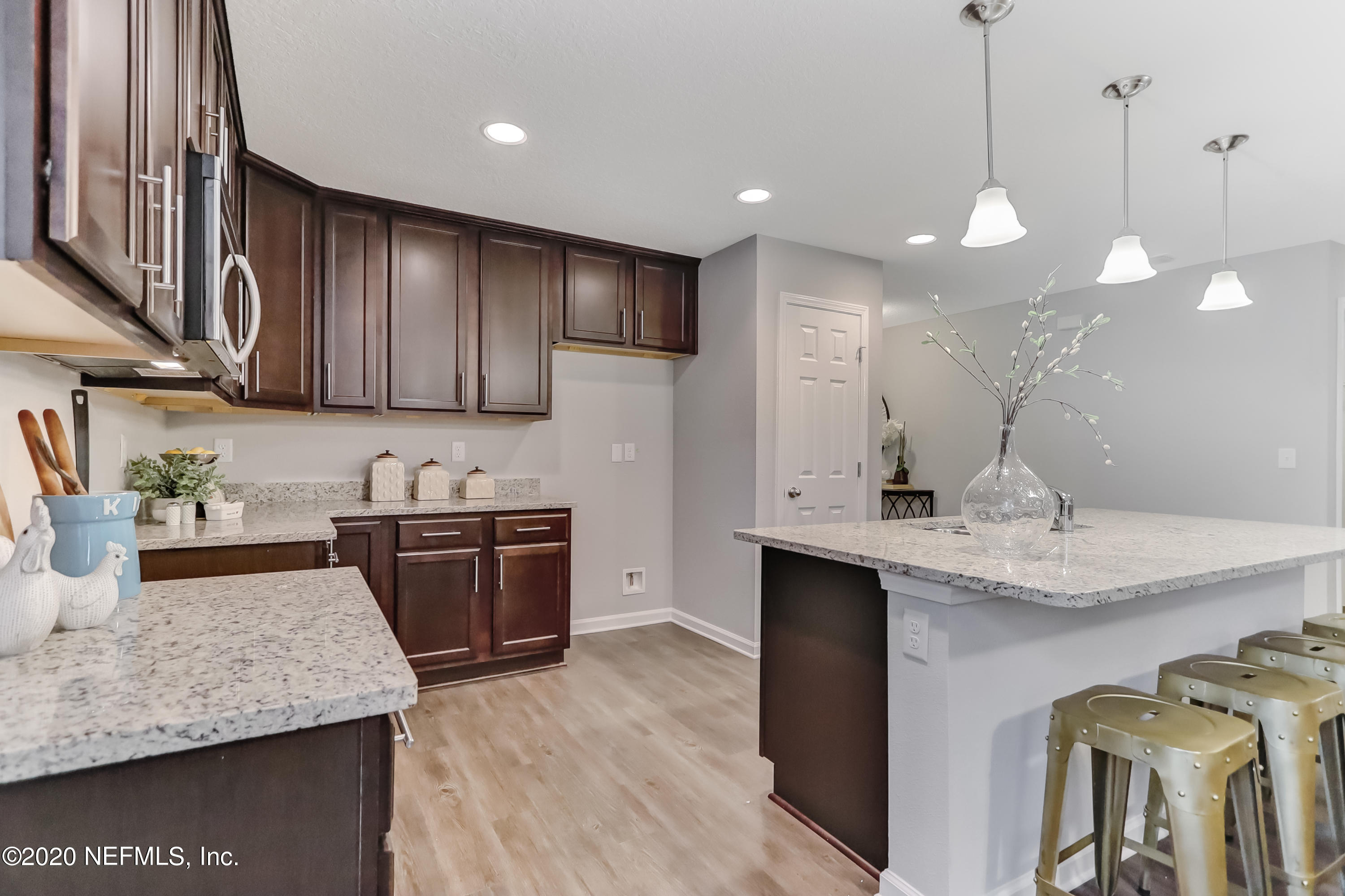5422 Kennerly Road Jacksonville, FL 32207 - Photo 9 of 41 a kitchen with stainless steel appliances granite countertop a sink a stove a refrigerator and a oven with wooden floor