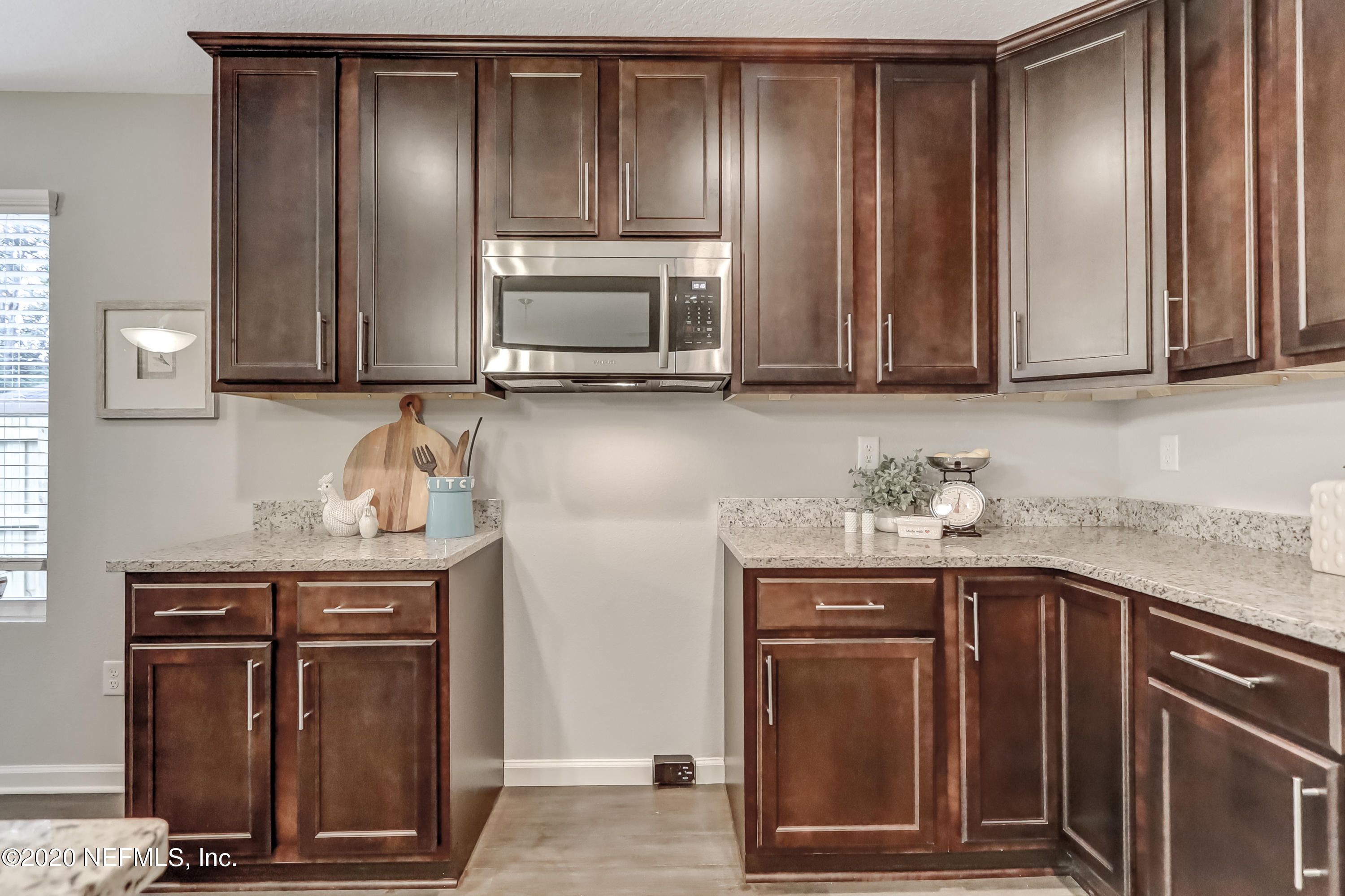 5422 Kennerly Road Jacksonville, FL 32207 - Photo 10 of 41 a kitchen with granite countertop stainless steel appliances wooden cabinets and a counter top space