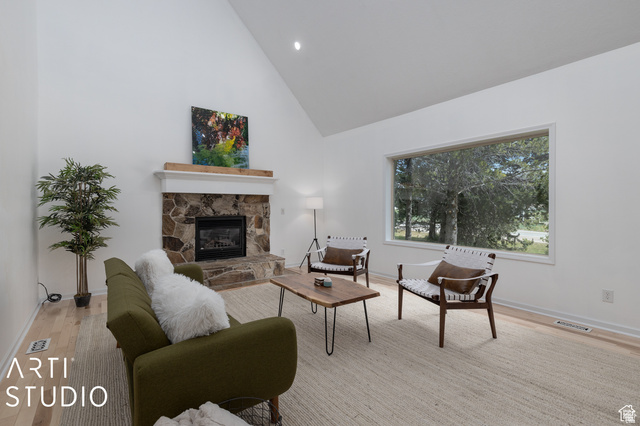 2807 North Ogden Canyon Road Eden, UT 84310 - Photo 19 of 72 Spacious living area featuring a stone fireplace with a wood mantle, vaulted ceilings, and large picture windows