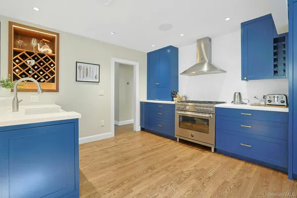 a kitchen with stainless steel appliances granite countertop a sink a stove and a refrigerator