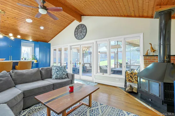 a living room with furniture a mirror and a fireplace
