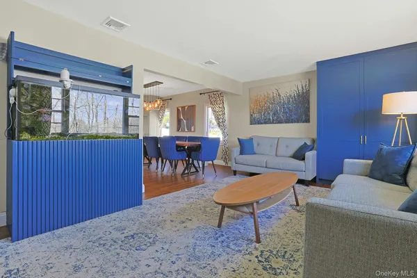 a living room with furniture a window and a table