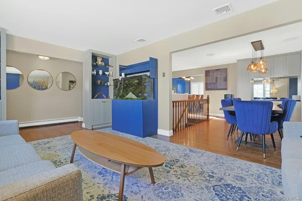 a living room with furniture and wooden floor