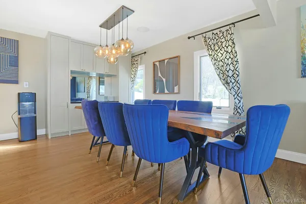 a view of a dining room with furniture a chandelier and wooden floor