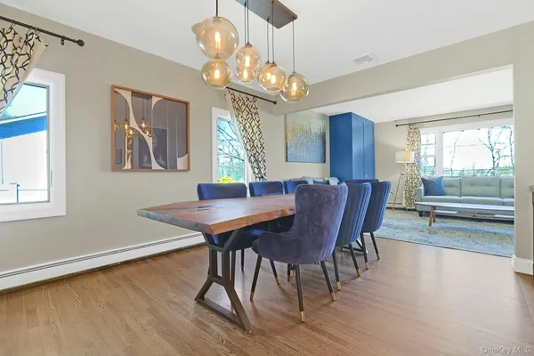 a view of a dining room with furniture wooden floor and chandelier