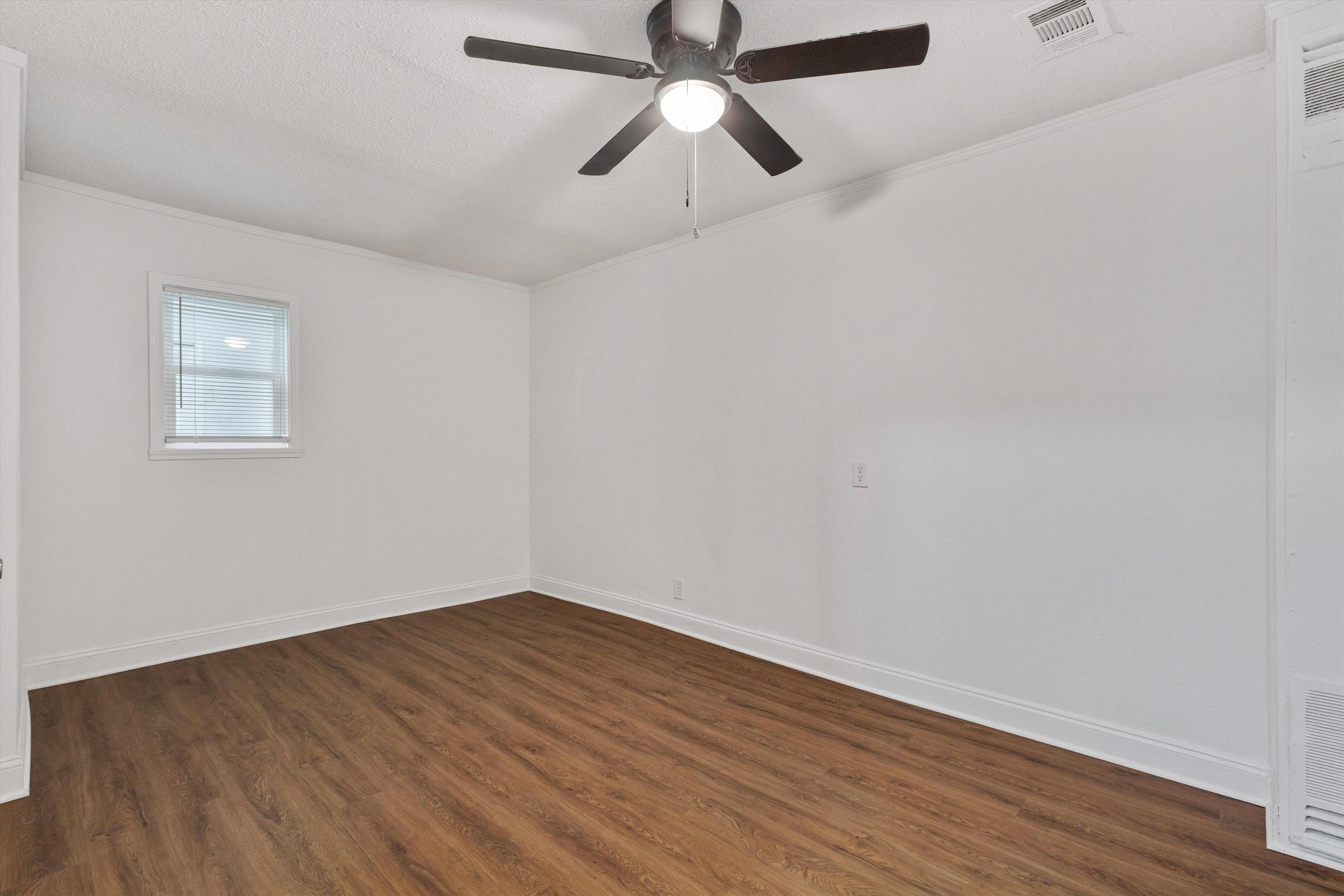 4565 Verne Road Memphis, TN 38117 - Photo 14 of 18 Room featuring wood-finish flooring, white walls, a ceiling fan with integrated lighting, a window with horizontal blinds, and white baseboards
