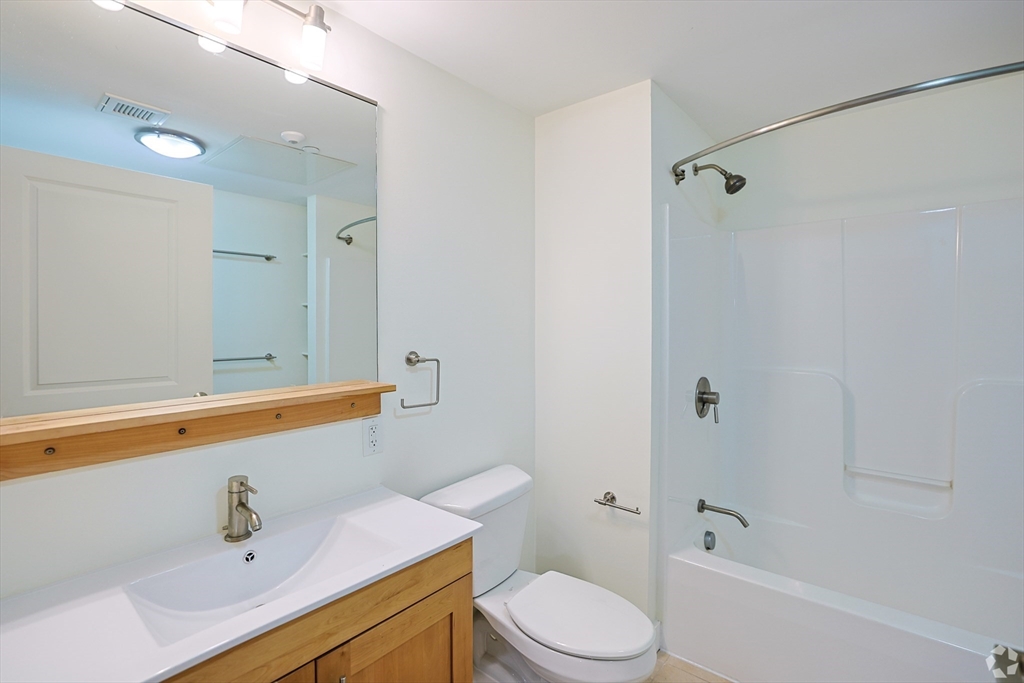 87 New Street, Unit 101 Cambridge, MA 02138 - Photo 5 of 11 a bathroom with a sink a toilet and shower