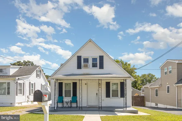 a front view of a house with swimming pool and yard