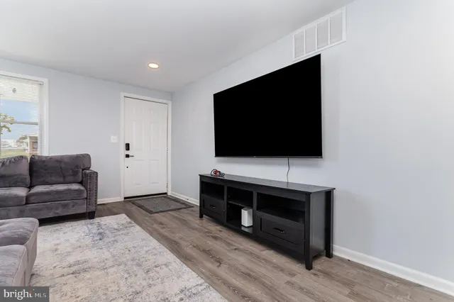 a kitchen with granite countertop a sink stove and cabinets