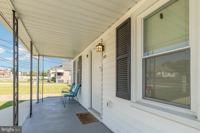 a view of a porch with a table and chair