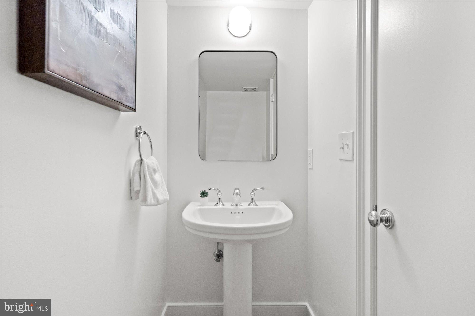 2145 N Street Northwest, Unit 3 Washington, DC 20037 - Photo 11 of 36 a bathroom with a sink a mirror and vanity