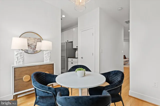 a dining room with furniture and a mirror