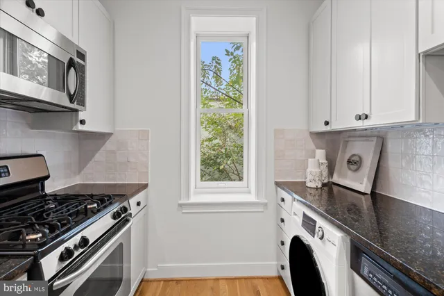 a kitchen with granite countertop a stove and a sink