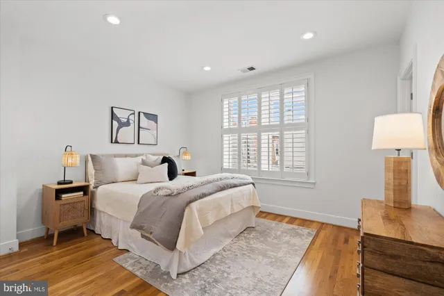 a spacious bedroom with a bed and a window