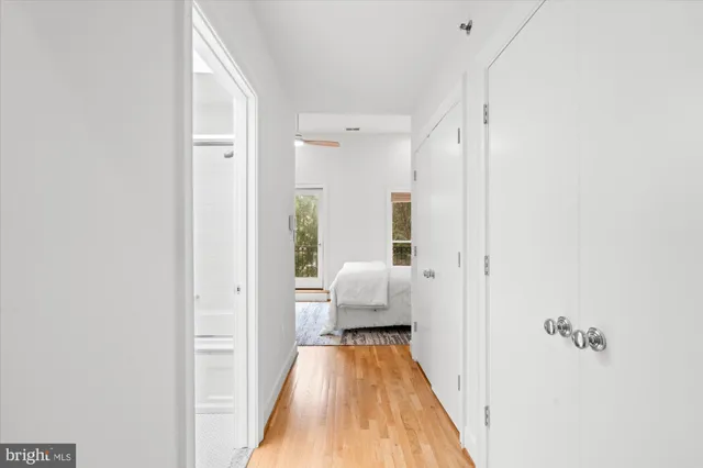 a view of a bedroom with a bed and wooden floor