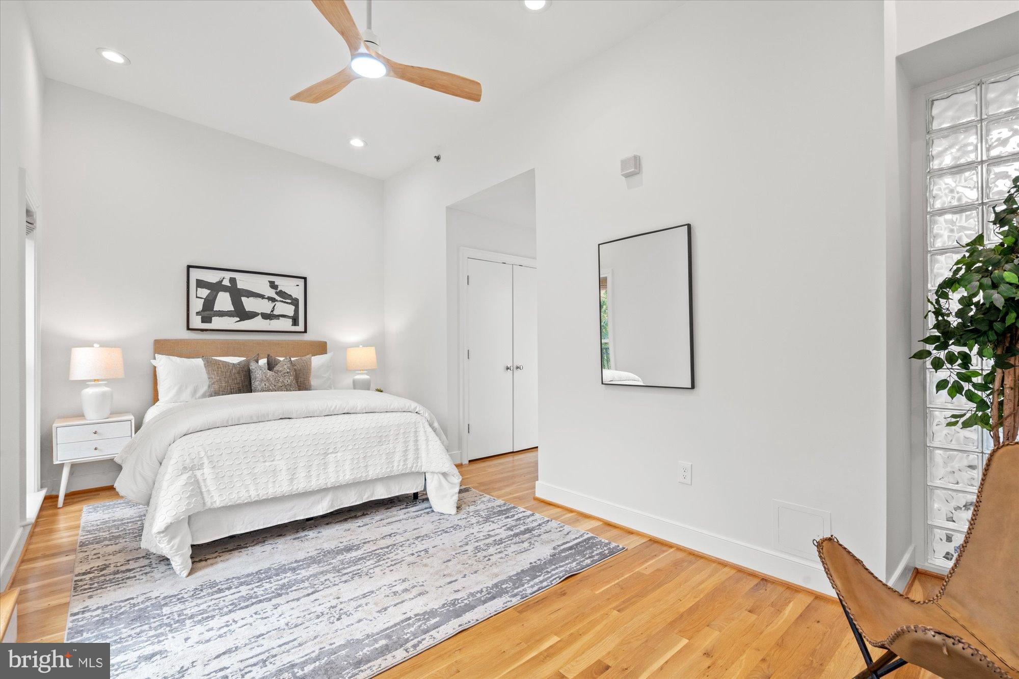 2145 N Street Northwest, Unit 3 Washington, DC 20037 - Photo 28 of 36 a bedroom with a large bed and a potted plant
