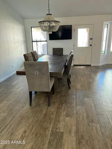 a view of a dining room with furniture window and wooden floor