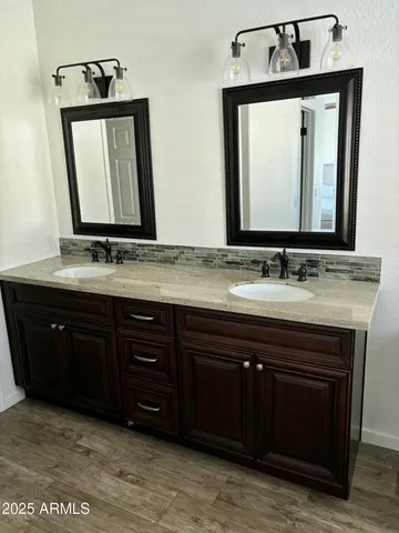 a bathroom with a sink vanity and a mirror