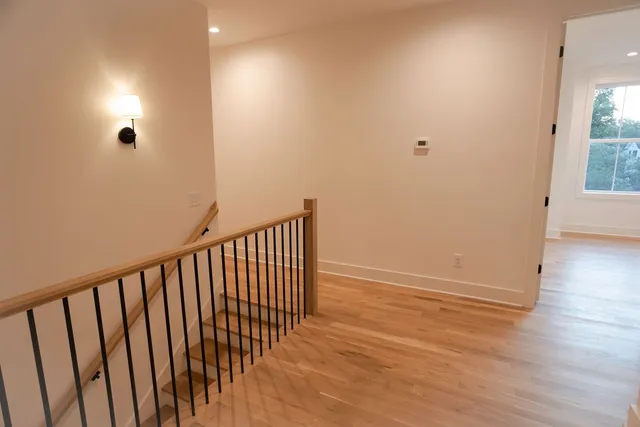 a view of hallway with wooden floor