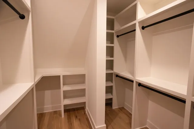 a view of walk in closet with empty racks