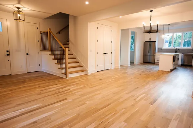 a view of a room with wooden floor and stairs