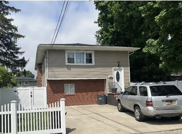 a front view of a house with parking space