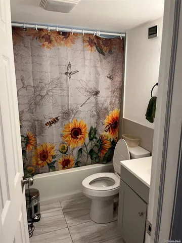 a bathroom with a toilet sink and shower