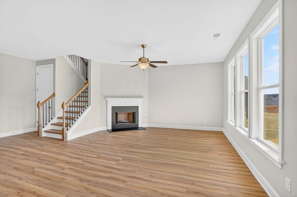 152 Classic Overlook Homer, GA 30547 - Photo 11 of 36 a view of an empty room with wooden floor fireplace and a window