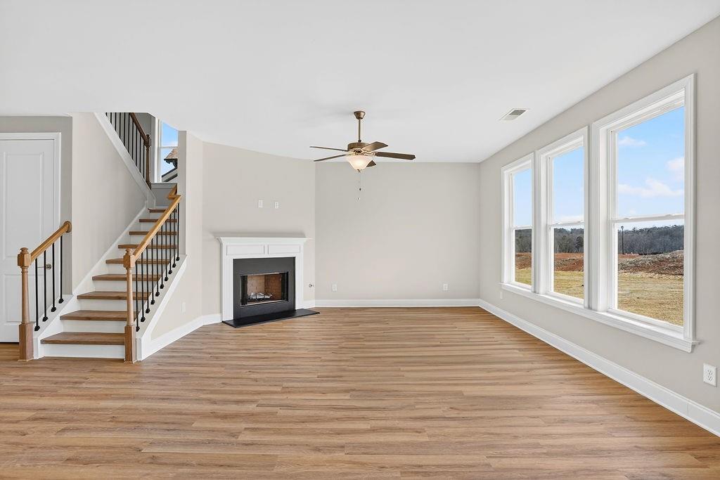 152 Classic Overlook Homer, GA 30547 - Photo 12 of 36 a view of an empty room with wooden floor fireplace and a window