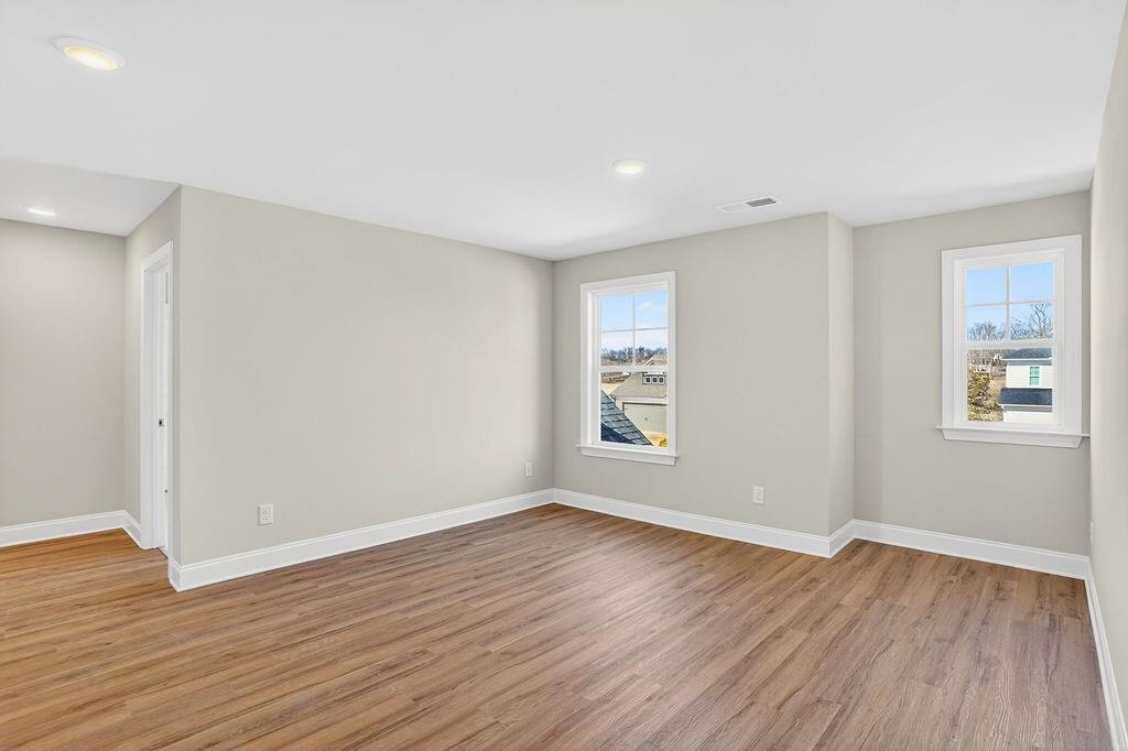 152 Classic Overlook Homer, GA 30547 - Photo 13 of 36 a view of an empty room with wooden floor and a window