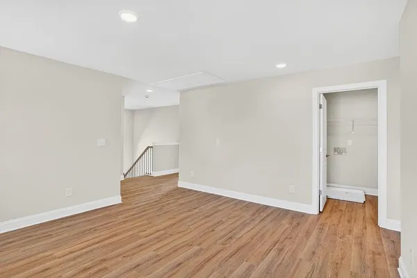 a view of empty room with wooden floor