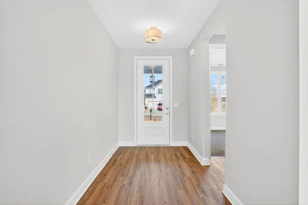 a view of a hallway view with wooden floor and staircase