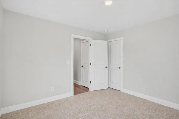 a view of an empty room and closet area
