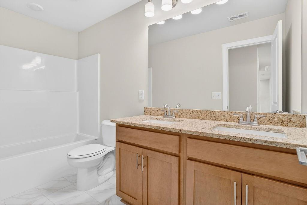 152 Classic Overlook Homer, GA 30547 - Photo 27 of 36 a bathroom with a granite countertop sink a toilet and a bathtub
